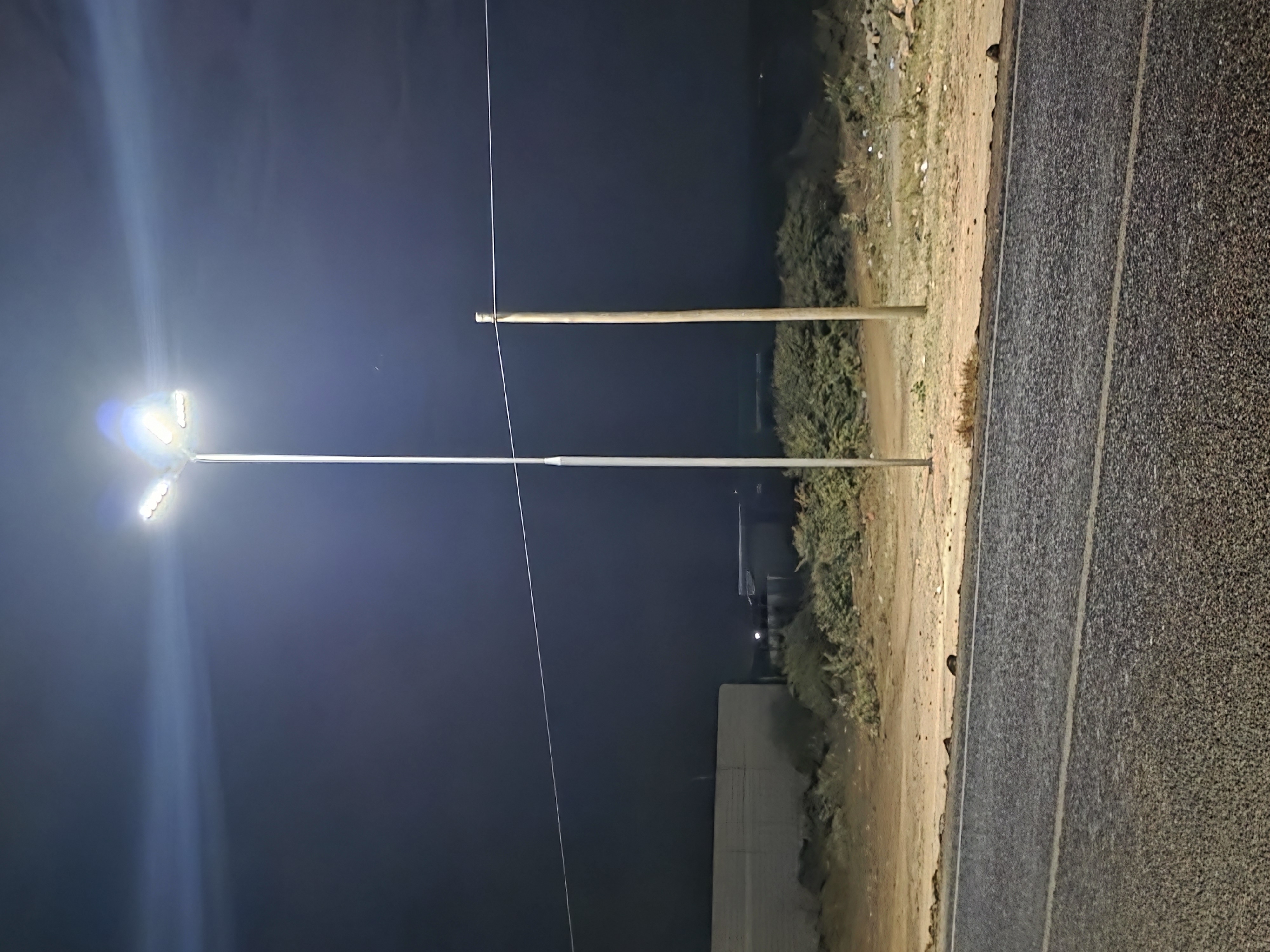 Solar streetlights illuminating an outdoor site during evening operations